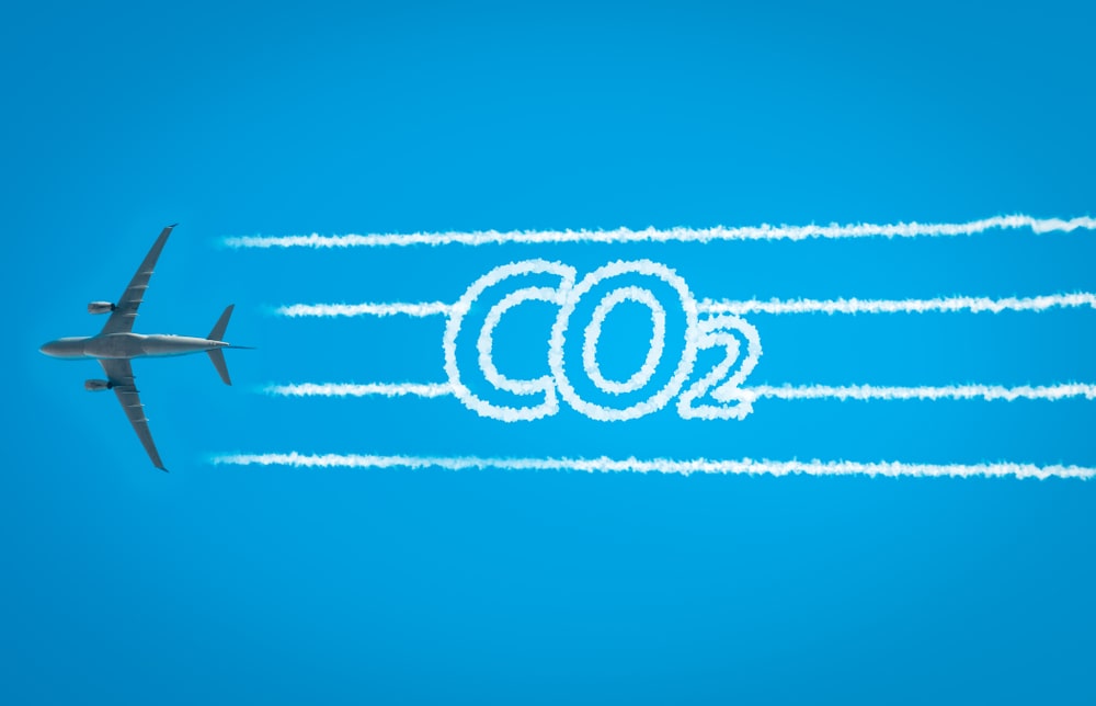 Plane flying to CO2 emissions in the air 